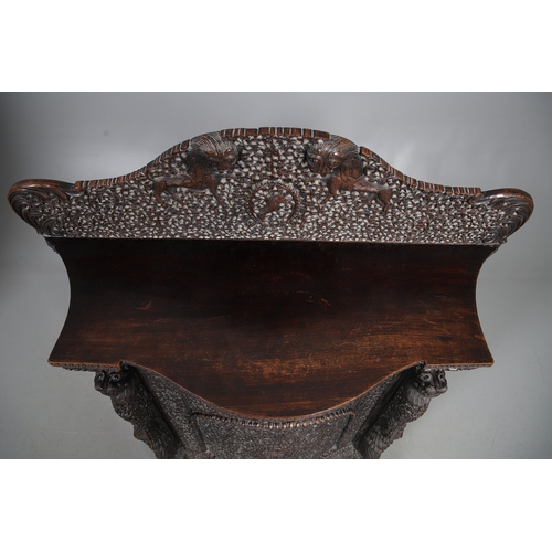 521 - A 19TH CENTURY BURMESE HARDWOOD SIDE CABINET. the raised back over a serpentine front and concave si... 