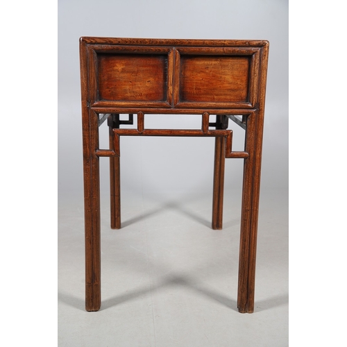 523 - A LATE 19TH/EARLY 20TH CENTURY CHINESE DONGSHAN ELM DESK. with three deep drawers to an open framewo... 