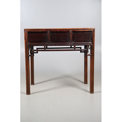 523 - A LATE 19TH/EARLY 20TH CENTURY CHINESE DONGSHAN ELM DESK. with three deep drawers to an open framewo... 