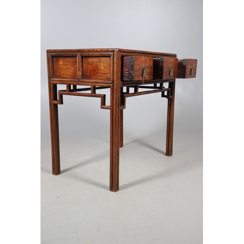 523 - A LATE 19TH/EARLY 20TH CENTURY CHINESE DONGSHAN ELM DESK. with three deep drawers to an open framewo... 