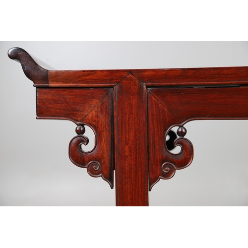 524 - A CHINESE HUANGHUALI HARDWOOD ALTER STYLE TABLE. mid-late 20th century, the scroll ended top with in... 