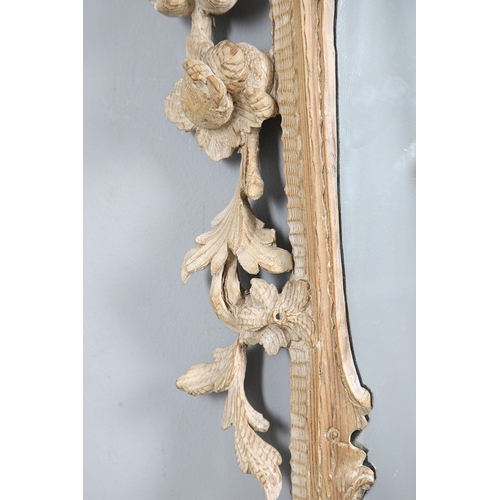 534 - AN 18TH CENTURY CARVED LIMEWOOD WALL MIRROR. the carved foliate and C-scroll surround to a later pla... 