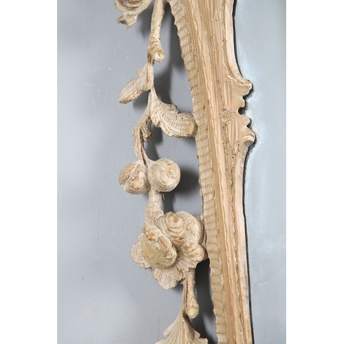 534 - AN 18TH CENTURY CARVED LIMEWOOD WALL MIRROR. the carved foliate and C-scroll surround to a later pla... 