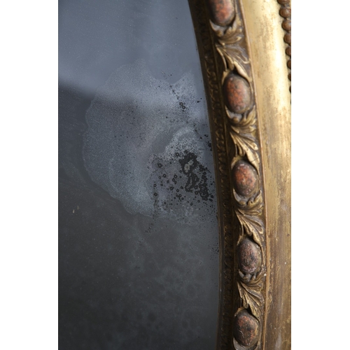 535 - A LARGE 19TH CENTURY GILT GESSO OVAL WALL MIRROR. the tripple section plate to a wire mounted gilt g... 