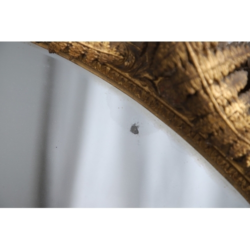 535 - A LARGE 19TH CENTURY GILT GESSO OVAL WALL MIRROR. the tripple section plate to a wire mounted gilt g... 