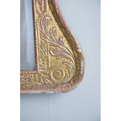 537 - A GEORGE II GILTWOOD AND GESSO OVERMANTLE MIRROR. the bevelled plate to a shallow-relief moulded fra... 