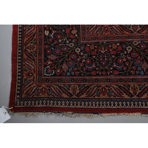 545 - A MASHAD CARPET, KHORASAN, CIRCA 1925. The raspberry field richly decorated with vines around a flow... 