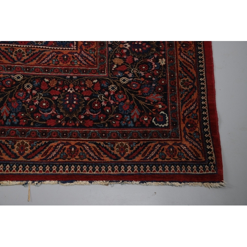 545 - A MASHAD CARPET, KHORASAN, CIRCA 1925. The raspberry field richly decorated with vines around a flow... 