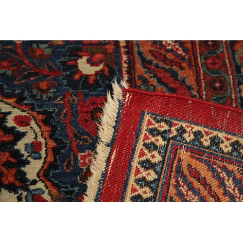 545 - A MASHAD CARPET, KHORASAN, CIRCA 1925. The raspberry field richly decorated with vines around a flow... 