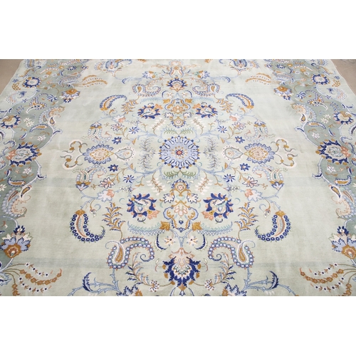 546 - A KASHAN CARPET, CIRCA 1970. The ice blue field centred by a flowerhead medallion surrounded by vine... 