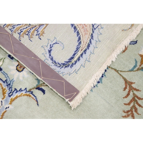 546 - A KASHAN CARPET, CIRCA 1970. The ice blue field centred by a flowerhead medallion surrounded by vine... 