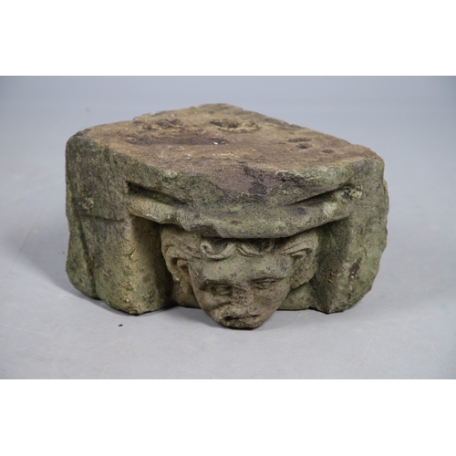 554 - A MEDIEVAL STONE CORBEL. possibly 15th century, carved with a head of a curly haired man, height 22c... 