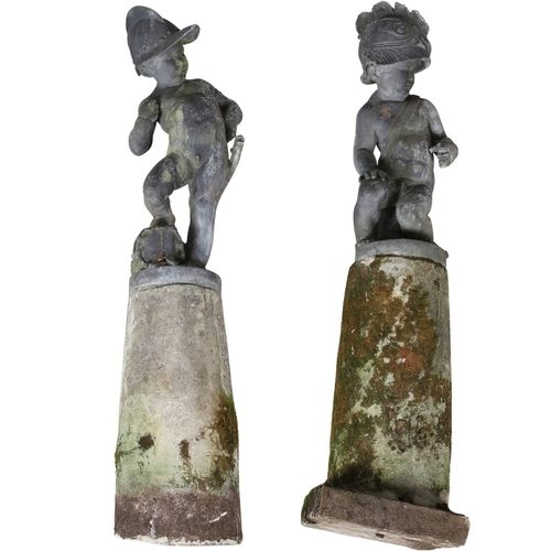 562 - A PAIR OF 19TH CENTURY LEAD GARDEN STATUES OF PUTTI. modelled wearing military style helmets, one wi... 