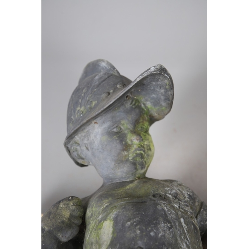 562 - A PAIR OF 19TH CENTURY LEAD GARDEN STATUES OF PUTTI. modelled wearing military style helmets, one wi... 