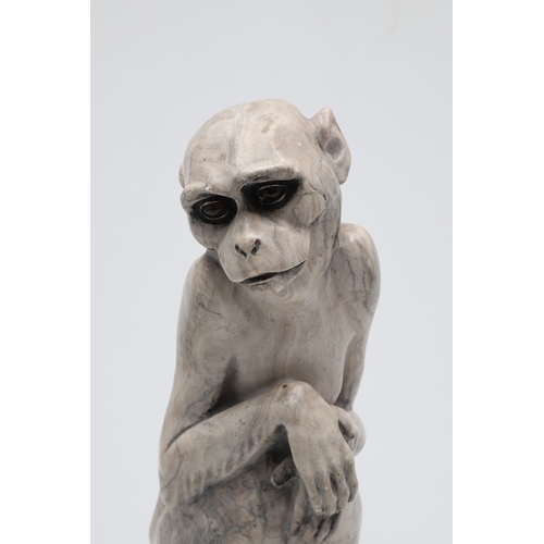 585 - SIGNED MARBLE SCULPTURE OF A RHESUS MONKEY. In the manner of Wilhelm Krieger, a carved marble figure... 