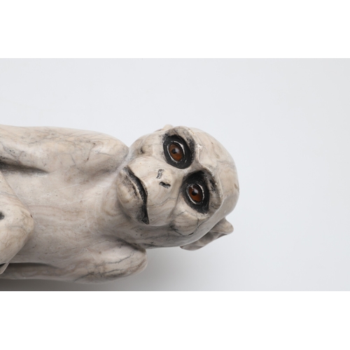 585 - SIGNED MARBLE SCULPTURE OF A RHESUS MONKEY. In the manner of Wilhelm Krieger, a carved marble figure... 