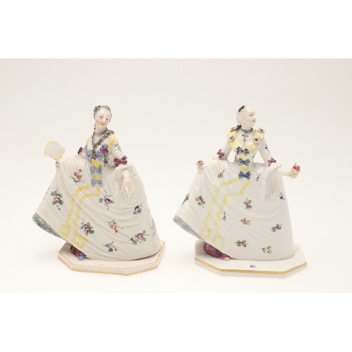 634 - NYMPHENBURG PORCELAIN FIGURES. Including two similar figures with one holding a fan (18cms high), an... 