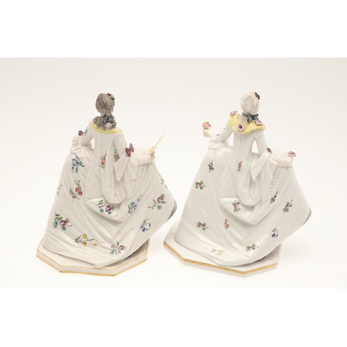 634 - NYMPHENBURG PORCELAIN FIGURES. Including two similar figures with one holding a fan (18cms high), an... 