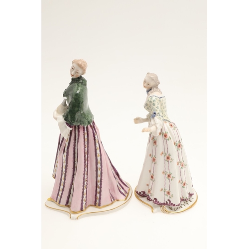 634 - NYMPHENBURG PORCELAIN FIGURES. Including two similar figures with one holding a fan (18cms high), an... 