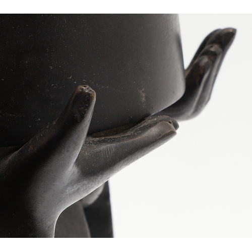 666 - JAPANESE BRONZE FIGURAL STAND. A bronze circular top stand made in two sections, supported by a figu... 