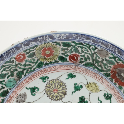 680 - LARGE CHINESE FAMILLE VERTE DISH. Kangxi period (1662-1722), the large shallow dish painted with a v... 