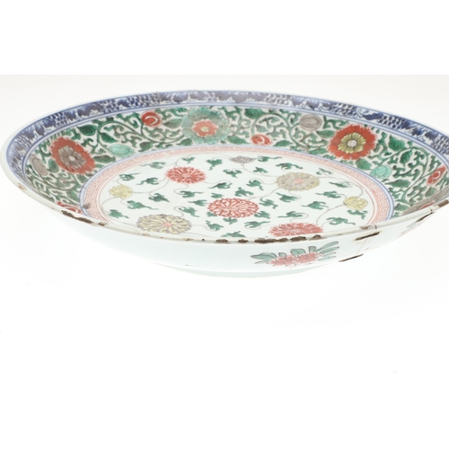 680 - LARGE CHINESE FAMILLE VERTE DISH. Kangxi period (1662-1722), the large shallow dish painted with a v... 