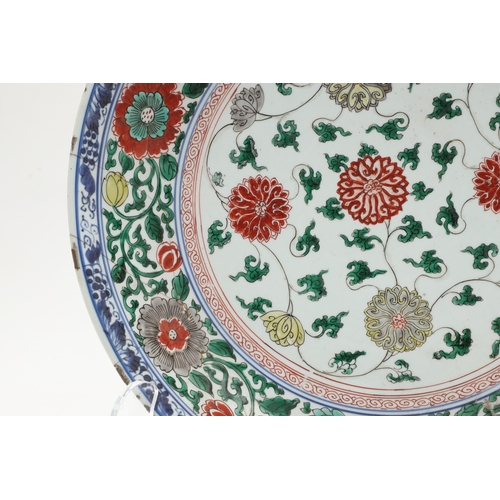 680 - LARGE CHINESE FAMILLE VERTE DISH. Kangxi period (1662-1722), the large shallow dish painted with a v... 