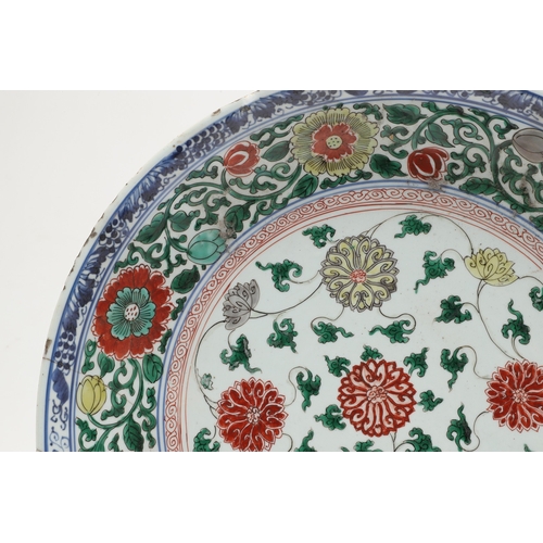 680 - LARGE CHINESE FAMILLE VERTE DISH. Kangxi period (1662-1722), the large shallow dish painted with a v... 