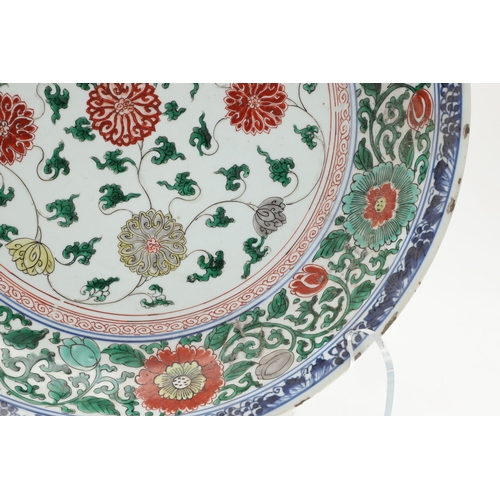 680 - LARGE CHINESE FAMILLE VERTE DISH. Kangxi period (1662-1722), the large shallow dish painted with a v... 