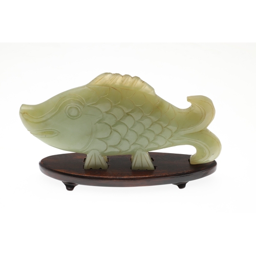 700 - CHINESE JADE FISH. Late Qing, the celadon jade fish of narrow form and with carved detailing. With a... 