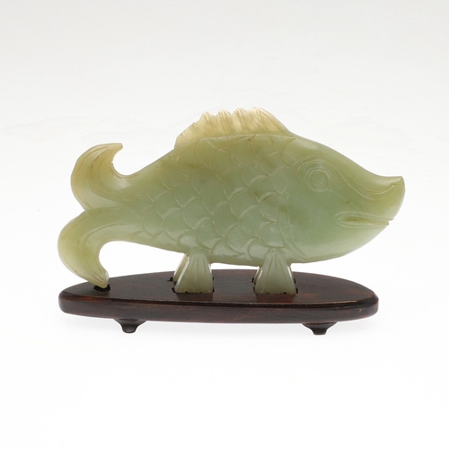 700 - CHINESE JADE FISH. Late Qing, the celadon jade fish of narrow form and with carved detailing. With a... 