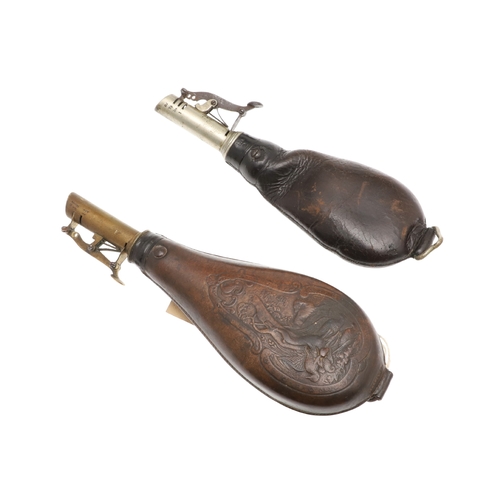 61 - TWO LEATHER BODIED SHOT FLASKS. A leather bodied shot flask decorated with game in a wooded landscap... 