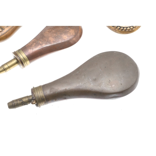 63 - A COLLECTION OF FOUR 19TH CENTURY BRASS MOUNTED COPPER POWDER FLASKS. A collection of four powder fl... 