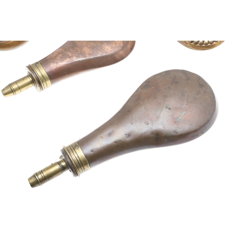 63 - A COLLECTION OF FOUR 19TH CENTURY BRASS MOUNTED COPPER POWDER FLASKS. A collection of four powder fl... 