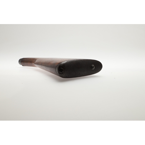 71 - A WALNUT RIFLE STOCK. A stock for a rifle with steel butt plate and small circular depression to the... 