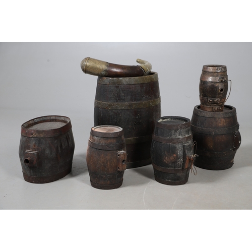 73 - A COLLECTION OF POWDER OR SIMILAR BARRELS AND A BRASS MOUNTED POWDER FLASK. A collection of bound ba... 