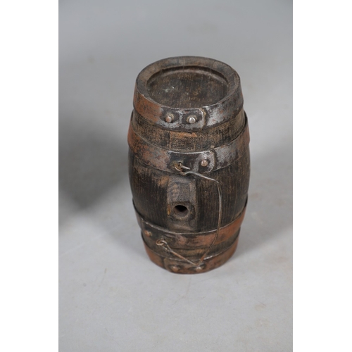 73 - A COLLECTION OF POWDER OR SIMILAR BARRELS AND A BRASS MOUNTED POWDER FLASK. A collection of bound ba... 