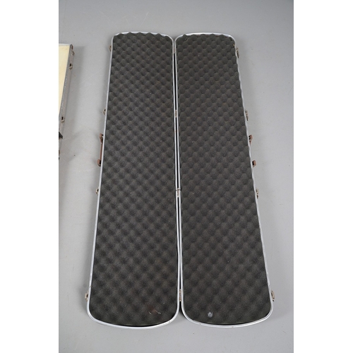 75 - TWO SIMILAR GUN CASES. Two similar hard-shell gun cases with foam lined interiors. 132 x 30 x 11 cm ... 