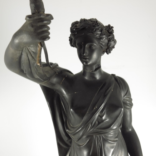 403 - REGENCY BLACK PAINTED FIGURAL TORCHERE MODELLED IN PLASTER AS A CLASSICAL MAIDEN HOLDING A LAMP, BAS... 