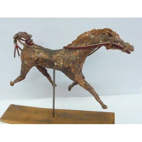 426 - A CAST SCULPTURE OF A RACE HORSE APPROX. HEIGHT 14 INS. X 13. INS LENGTH, ON A METAL STAND ON A WOOD... 