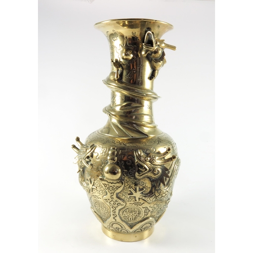 453 - CHINESE QUING STYLE POLISHED BRONZE VASE WITH RELIEF DRAGON DECORATION ON A HARDWOOD STAND