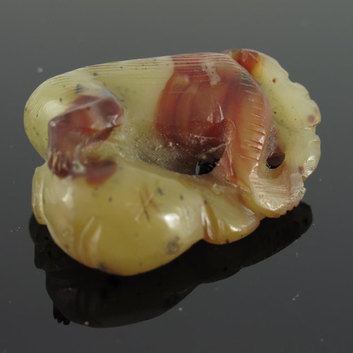 456 - CHINESE CELADON AND RUSSET JADE DEPICTING A RECUMBENT MONKEY, APPROX. 4 X 3.6 cm