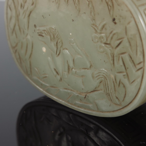 471 - CHINESE JADE BOX AND COVER OF OVAL FORM, THE COVER CARVED WITH A MYTHICAL CREATURE, TREES AND FOLIAG... 