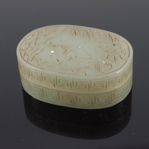 471 - CHINESE JADE BOX AND COVER OF OVAL FORM, THE COVER CARVED WITH A MYTHICAL CREATURE, TREES AND FOLIAG... 