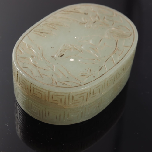 471 - CHINESE JADE BOX AND COVER OF OVAL FORM, THE COVER CARVED WITH A MYTHICAL CREATURE, TREES AND FOLIAG... 