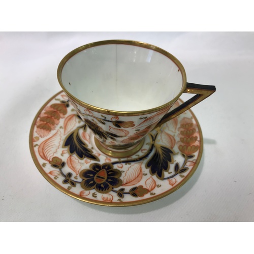 444 - AN IMARI PATTERN CUP AND SAUCER BEARING REGISTERED DESIGN MARK, HAIRLINE CRACK TO CUP