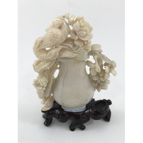 1966 - OPAL BOTTLE WITH CARVED RELIEF DECORATION DEPICTING FLOWERS AND BIRD FINIAL APPROX 12 cm ON HARDWOOD... 