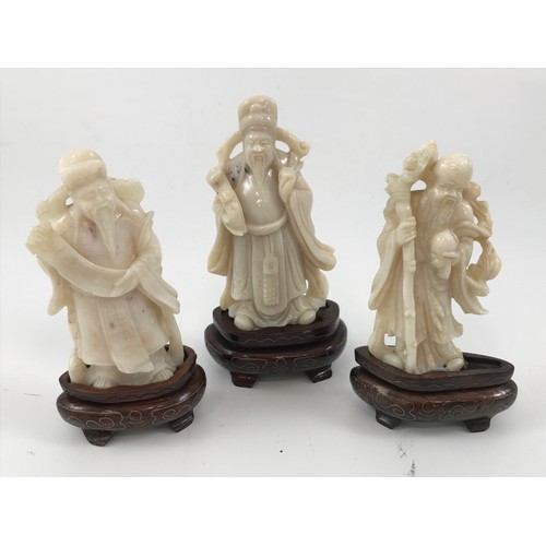 1967 - 3 CARVED OPAL FIGURINES DEPICTING SAN-XING, TALLEST APPROX 9 cm AND EACH ON A HARDWOOD PRESENTATION ... 