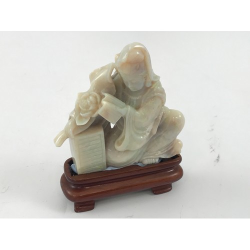 1986 - OPAL CARVING DEPICTING A LADY WITH BOOK AND LOTUS APPROX 6.5 cm ON HARDWOOD STAND