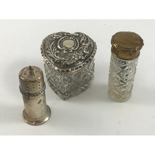 1926 - HEART SHAPED DRESSING TABLE BOTTLE WITH EMBOSSED SILVER COVER, 1 OTHER AND A SILVER PEPPER